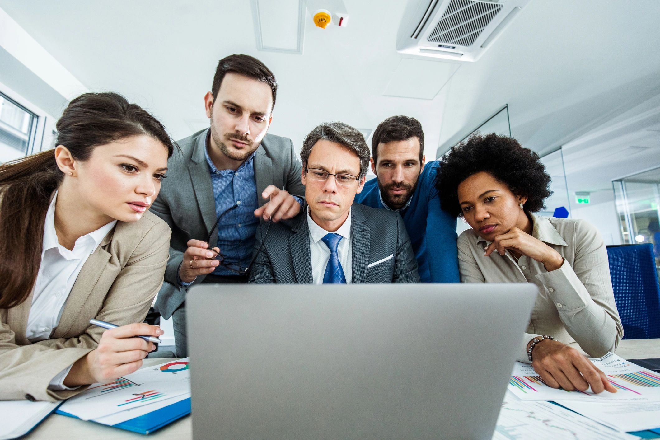 Team collaborating on a laptop in an office