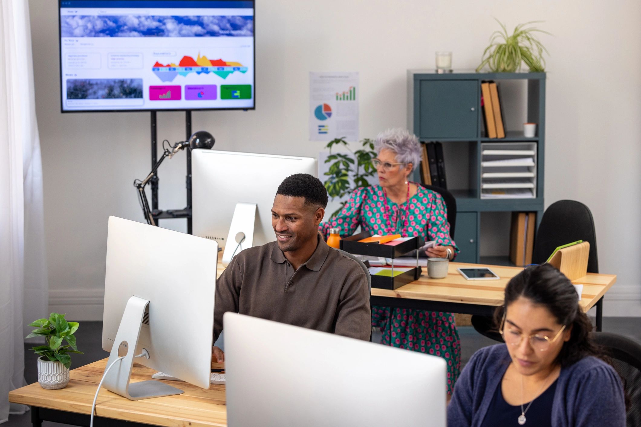 Operations team monitoring dashboards in a modern office
